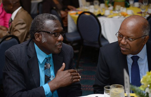 Jermaine Barnaby/Photographer
Rev. ConradPitkins (left) of the Montego Bay Assembles of God, making a point to Morais Guy while at the table at the annual National Leadership Prayer Breakfast at the  Jamaica Pegasus Hotel in New Kingston on Thursday, January 21, 2016.