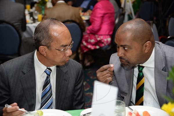Jermaine Barnaby/Photographer
Julian Robinson (right) making a point to Horace Chang at the annual National Leadership Prayer Breakfast at the  Jamaica Pegasus Hotel in New Kingston on Thursday, January 21, 2016.