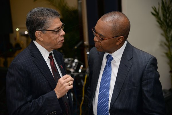 Jermaine Barnaby/Photographer
Richard Powell (left) president and chief executive officer Victoria Mutual  making a point to Rev. Dr. Stevenson Samuels chairman of the National Leadership Prayer Breakfast Committee at the 36th staging of the annual National Leadership Prayer Breakfast at the  Jamaica Pegasus Hotel in New Kingston on Thursday, January 21, 2016.