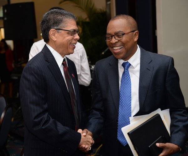 Jermaine Barnaby/Photographer
Richard Powell (left) president and chief executive officer Victoria Mutual  having a light moment with Rev. Dr. Stevenson Samuels chairman of the National Leadership Prayer Breakfast Committee at the 36th staging of the annual National Leadership Prayer Breakfast at the  Jamaica Pegasus Hotel in New Kingston on Thursday, January 21, 2016.