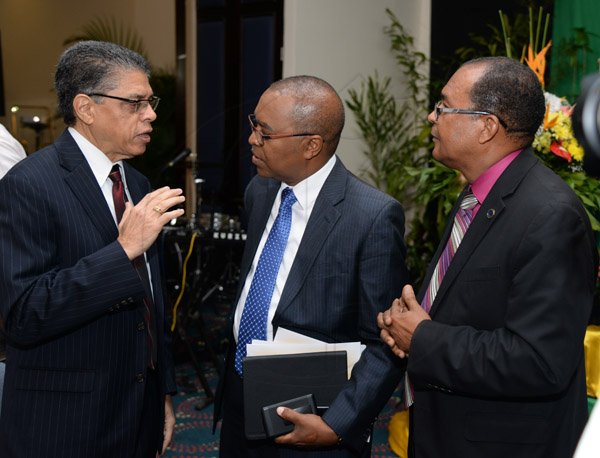 Jermaine Barnaby/Photographer
Richard Powell (left) president and chief executive officer Victoria Mutual  making a point to Rev. Dr. Stevenson Samuels chairman of the National Leadership Prayer Breakfast Committee and Rev. Peter Garth (right) past chairman of the National Leadership Prayer Breakfast committee at the 36th staging of the annual National Leadership Prayer Breakfast at the  Jamaica Pegasus Hotel in New Kingston on Thursday, January 21, 2016.