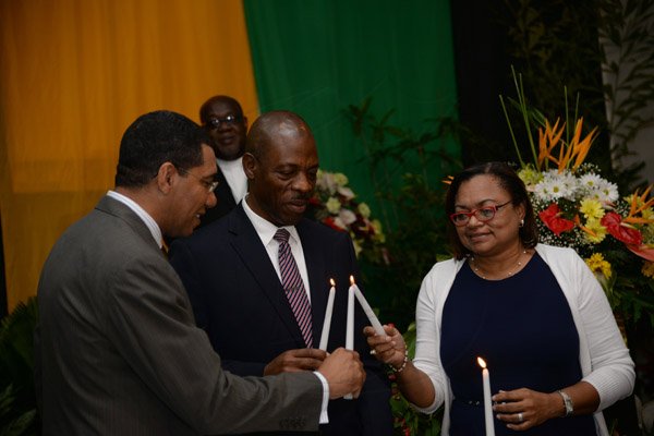 Jermaine Barnaby/Photographer
Opposition Leader Andrew Holness (left)  light candles as a symbol of national unity with Dr. Carl Williams Commissioner of Police at the annual National Leadership Prayer Breakfast at the  Jamaica Pegasus Hotel in New Kingston on Thursday, January 21, 2016.