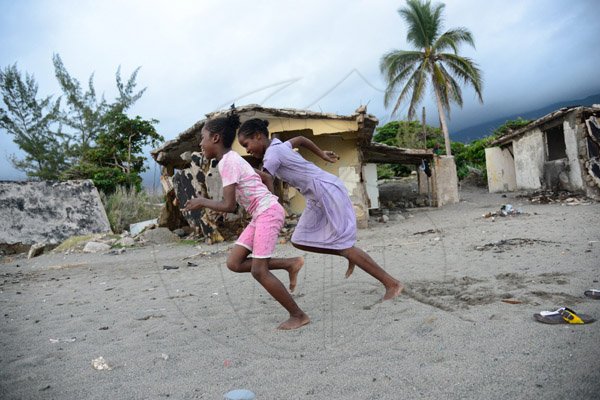 Gladstone Taylor / PhotographerChildren Innocently play on the sands of the caribbean terrace community amidst the destruction of hurricane's