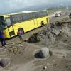 Rudolph Brown/PhotographerA JUTC bus pass has workmen's remove a pile up of sand and silt from the palisadoes main road in Kingston from High tides and high winds, related to Hurricane Matthew on Saturday, October 1, 2016