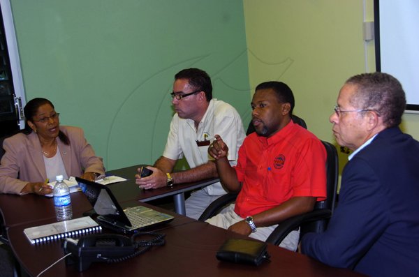 Norman Grindley/Chief Photographer
Prime Minister Bruce Golding, (right) got an update Ronald Jackson,(second right) Director-General of the Office of Disaster Preparedness and Emergency Management and Sylvia McGill (left) National Meteorological Service on Tropical storm Tomas at ODPEM office in St. Andrew yesterday. Looking on is Information minister Daryl Vaz,