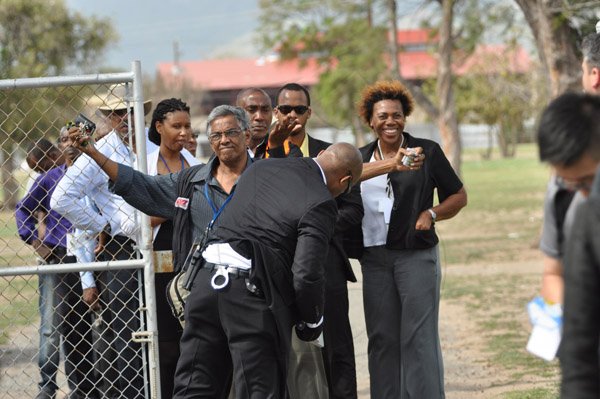 Jermaine Barnaby/Photographer
Jamaican media personnel being checked by security just before US President Barrack Obama laid a wreath at National Heroes Park on Thursday April 9, 2015.