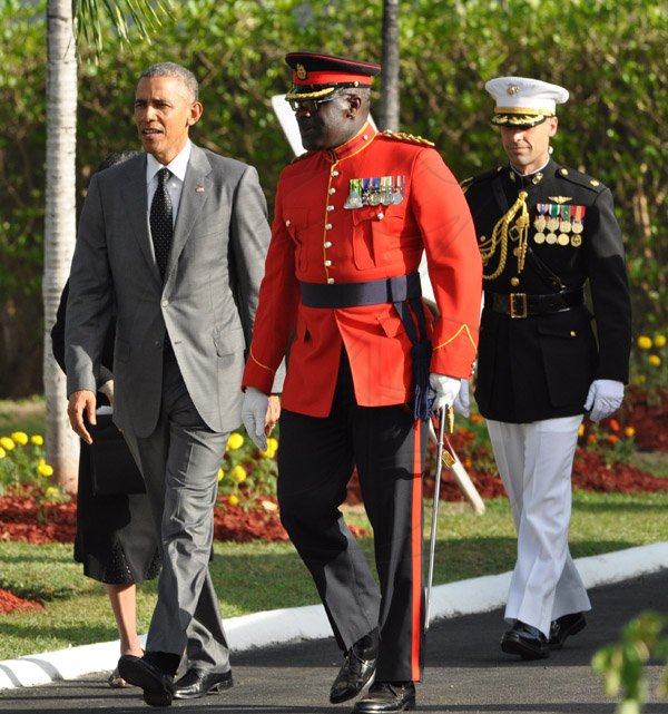 Jermaine Barnaby/Photographer
Colonel Daniel Pryce guides US President Barrack Obama just before he laid a wreath at National Heroes Park on Thursday April 9, 2015.