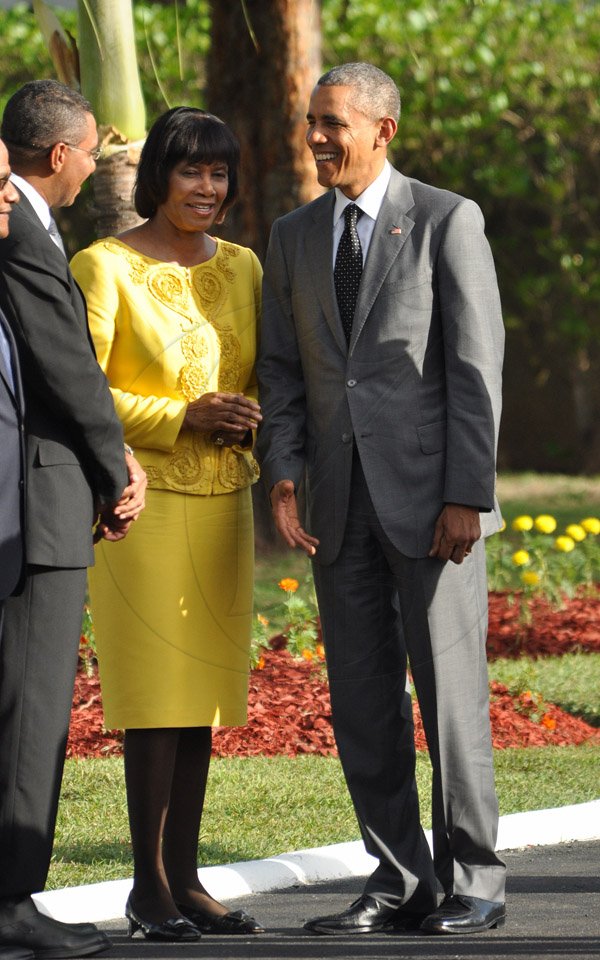 Jermaine Barnaby/Photographer
Prime Minister Portia Simpson Miller (left) has a discussion with US President Barrack Obama wreath laying at National Heroes Park on Thursday April 9, 2015.
