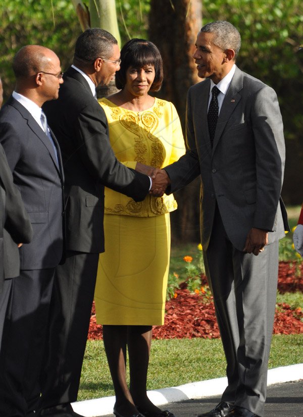 Jermaine Barnaby/Photographer
US President Barrack Obama shakes the hand of Opposition leader Andrew Holness just befire he laid a wreath at National Heroes Park on Thursday April 9, 2015. Looking on is Prime Minister Portia Simpson Miller and Peter Bunting security minister.