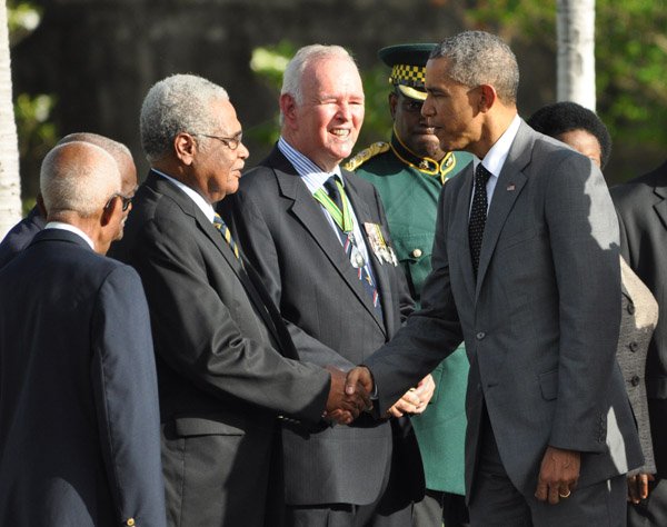 Jermaine Barnaby/Photographer
US President Barrack Obama (right) meets with World War 11 veteran colonel Torrance Lewis just before he laid a wreath at National Heroes Park on Thursday April 9, 2015. Looking on his World War 11 veteran Barry Beckford and Major Victor Beek.