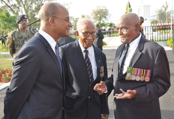 Jermaine Barnaby/Photographer
Security Minister Peter Bunting (left) congratu;ates world war 11 veterans Barry Beckford (center) and major Victor Beek (right) following the US President Barrack Obama wreath laying at National Heroes Park on Thursday April 9, 2015.