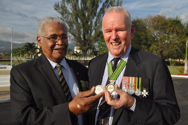 Jermaine Barnaby/Photographer
Colonel Torrance Lewis (left) and Major General Robert Neish shows off a coin they received from US President Barrack Obama just before he laid a wreath at National Heroes Park on Thursday April 9, 2015.