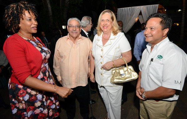 Rudolph Brown/Photographer
Opal Levy –Clarke, (left) International Private Banker of  Scotia Private Client Group chat with from right Omar Azan, CEO of BOSS, Janet Stewart and James Moss Solomon at Scotia Private Client Group cocktail at the Terra Nova Hotel in Kingston on Thursday, January 22, 2016
