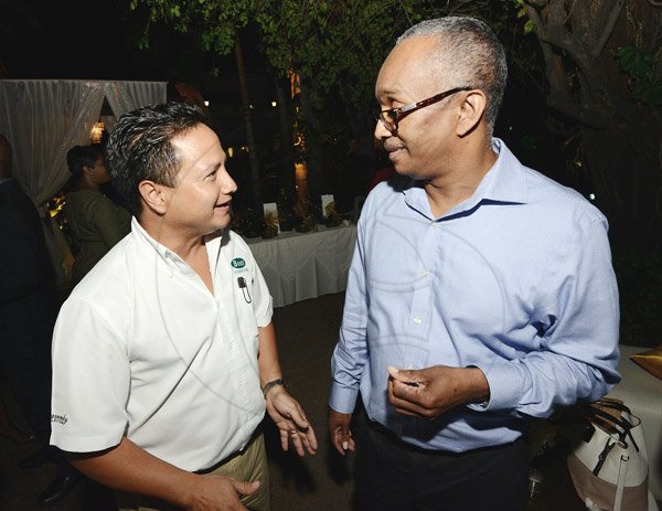 Rudolph Brown/Photographer<\n>Dennis Harris, Unicomer (Jamaica) Limited managing director (right)chat with Omar Azan of Boss Furniture Limited at the Scotia Private Client Group cocktail at the Terra Nova Hotel in Kingston on Thursday, January 22, 2016