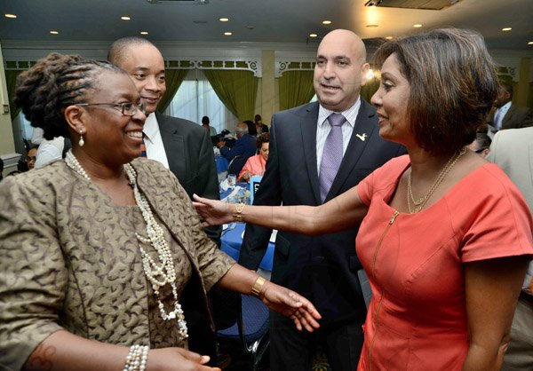 Rudolph Brown/Photographer
Business Desk
Guest speaker Dr. Claire Nelson, (left) President of Institute of Caribbean Studies greets from right Bernadette Barrow, assistant general manager, Small and Medium Enterprise, retail banking division, NCB, Christopher Zacca, president of the Private Sector Organisation of Jamaica, (PSOJ)  and Dennis Chung at the PSOJ Chairman Club Forum breakfast meeting at Knutsford Court Hotel in Kingston on Tuesday, May 28, 2013
