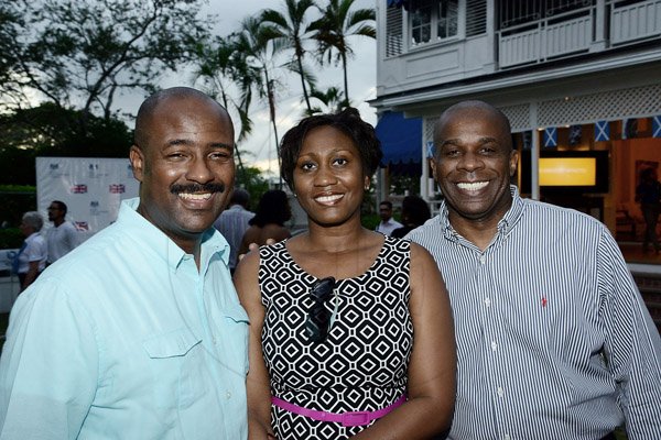 Diahann Gordon Harrison (middle) is sandwiched by husband Dirk Harrison (left) and Greg Christie (right) 
Winston Sill/Freelance Photographer
British High Commissioner David Fitton host Welcome Reception for the arrival of the Queen's Baton, held at Trafalgar House, Trafalgar Road on Saturday evening April 5, 2014.