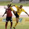Ricardo Makyn/Staff Photographer.
Jamaica's Rudolph Austin (right and Trinidad and Tobago's Trent Noel battle for possession during the match.