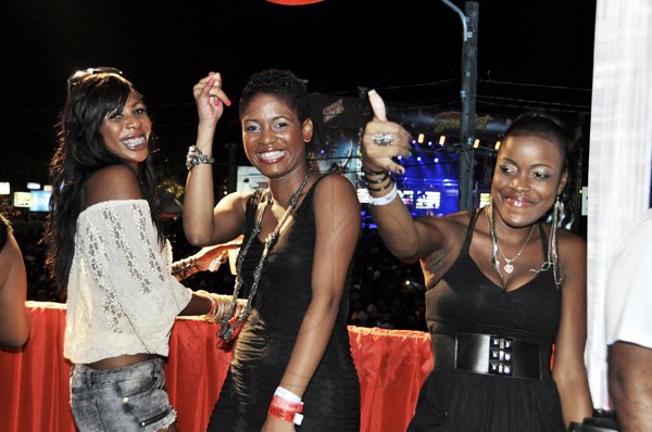 From L- Dimari Samuels, Abbygay Dallas and Diandra Young enjoying every moment of I-Octane at the Digicel booth at Reggae Sumfest 2K11 at Catherine Hall in Montego Bay last Friday night