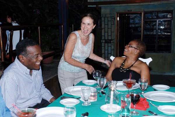 Colin Hamilton/Freelance Photographer
Enola Williams (standing) gets a joke from Karin Cooper, The Gleaner's Business Development & Marketing manager and her husband Howard Cooper, at the pre-Restaurant Week dinner at Redbones on Wednesday night.

*************************************************************************.
RW Week Dining on November 9, 2011
At Redbones, Redbones owner (standing) shares a joke with Karin and Howard Cooper.