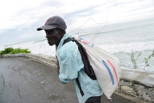 Rudolph Brown/Photographer
Neville Anderson farmer making his way on Eastern coastline back to regular everyday duty in St Thomas after passing of Hurricane Matthew on Tuesday, October 4, 2016