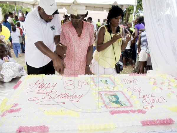 Contributed
From left: Member of Parliament  Rudyard Spencer helps Rezna Miller and daughter Lorna Miller to cut the birthday cake.