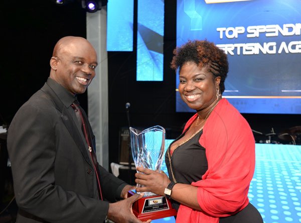 Jermaine Barnaby/ Freelance PhotographerDorothy Duncan (right) accepting the top spending advertising agency award for RJR from Dr. Orville Taylor during the RJRGLEANER CLIENT APPRECIATION AWARDS at the Sunken Gardens at Hope Botanical Gardens on Thursday, June 22, 2017.