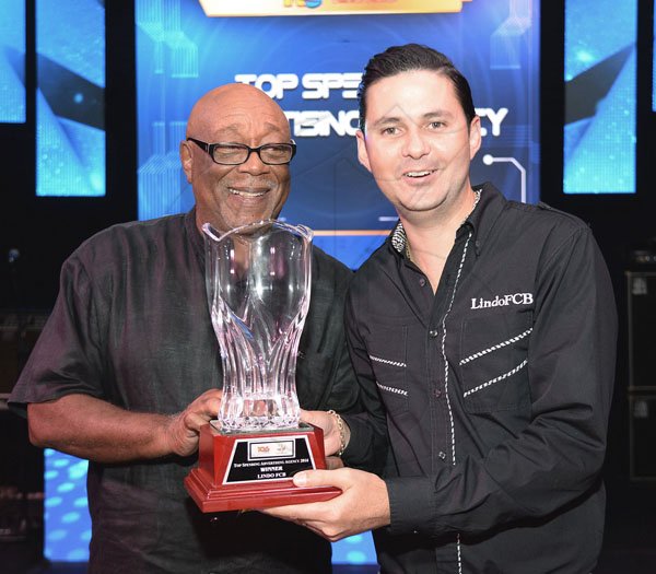 Jermaine Barnaby/ Freelance Photographer<\n>Maurice Foster (left) presenting the top spending advertising agency for Power 106 to Sean Duquesnay during the RJRGLEANER CLIENT APPRECIATION AWARDS at the Sunken Gardens at Hope Botanical Gardens on Thursday, June 22, 2017. *** Local Caption *** @Normal:Maurice Foster (left) presenting the Top Spending Advertising Agency Award for Power 106 and Music 99 FM to Sean Duquesnay of Lindo FCB.