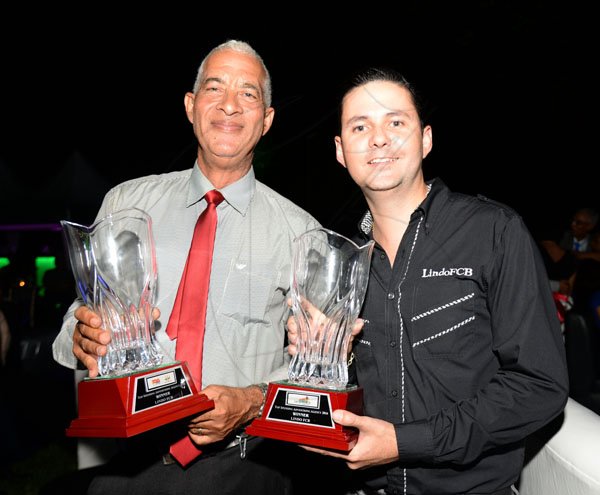 Jermaine Barnaby/ Freelance PhotographerSean Duquesnay (right) and Sheldon Neil posing with the top spending advertising agency awards for Power 106 and Go Jamaica during the RJRGLEANER CLIENT APPRECIATION AWARDS at the Sunken Gardens at Hope Botanical Gardens on Thursday, June 22, 2017.