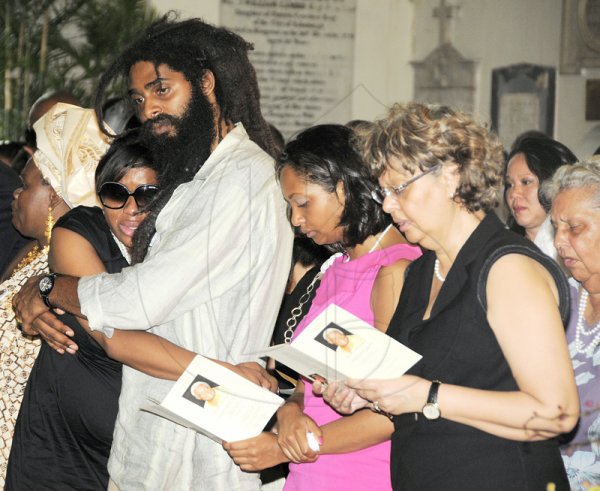 Gladstone Taylor / Photographer

From left: Pat Francis, widow of slain businessman Roderick 'Bunny' Francis.,  daughter Venessa, son  Shawn and other family members celebrate Bunny's life at a moving thanksgiving service held at  the St. Andrew Parish Church yesterday. Francis was murdered last Saturday as he drove out of his Queensway Drive in Kingston.