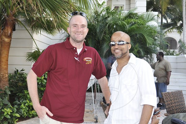 Janet Silvera Photo
Flow's Ben Buls (left) and IT specialist Franz Wiggan at ADS Global's Ron McKay's poolside party with his 'breddas' at the Palmyra Resort and Spa in Montego Bay last Saturday afternoon