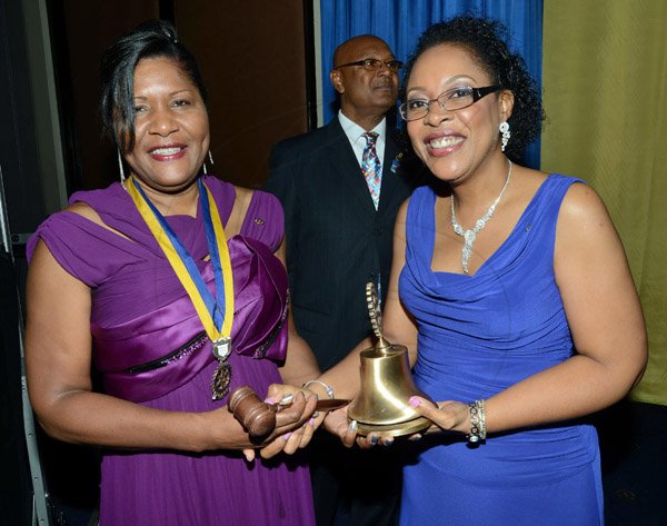 Rudolph Brown/ Photographer
Business Desk
Outgoing President  of the Rotary Club of St Andrew Judy Hylton, (right) hands the gavel and the bell to incoming president Marie Powell after she was installed at the club Installation banquet at the Jamaica Pegasus Hotel in New Kingston on Tuesday, July 9, 2013.
