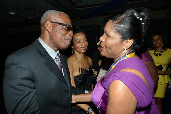 Rudolph Brown/ Photographer
Rion Hall and his wife Viviene greets new president Marie Powell, (right) after she was installed president of the Rotary Club of St. Andrew at the club Installation banquet at the Jamaica Pegasus Hotel in New Kingston on Tuesday, July 9, 2013.
