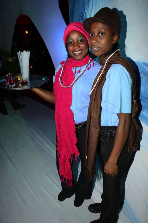 Rudolph Brown/Photographer
Dazia Simpson, (left) and Audette Smith of Top Shelf pose at the Sagicor Christmas party at the office car park in New Kingston on Saturday, December 3-2011