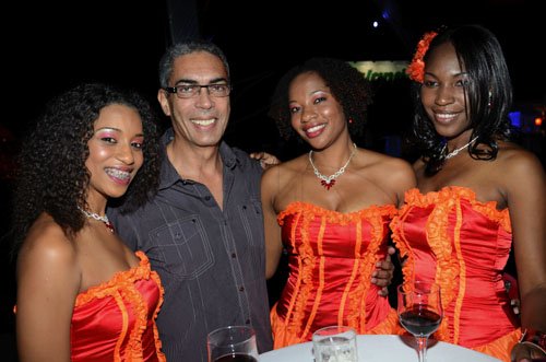 Rudolph Brown/Photographer
Richard Byles, president and chief executive officer of Sagicor Life Jamaica, pose with from left Shanique Clarke, Kay-Ann White and Gayanna Campbell at the Sagicor Christmas party at the office car park in New Kingston on Saturday, December 3-2011