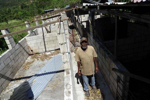 Ricardo Makyn/Staff Photographer
`Shadrack Wilson a Farmer in   Lloyd's St Thomas  In His  Pig Pen that was damaged during   the passage of Hurricane Sandy