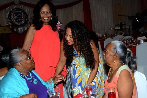 Winston Sill/Freelance Photographer
PUBLIC AFFAIRS DESK:------ Rachel McLarty (second right), greets Maxine Henry-Wilson (left). Looking on are Dorothy Pine-McLarty (second left), and Dr Deanna Ashley. They were attending the St Andrew Old Girls Association (SAOGA)  annual Valentine Dinner and Dance, held at Terra Nova All-Suite Hotel, Waterloo Road on Saturday night February 7, 2015.