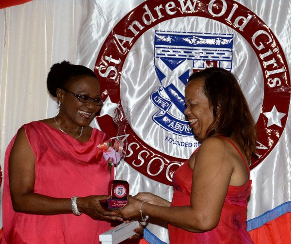 Winston Sill/Freelance Photographer
PUBLIC AFFAIRS DESK:------ Fay McIntosh (left) receives the Saint Award from Marlize McCartney at the St Andrew Old Girls Association (SAOGA)  annual Valentine Dinner and Dance, held at Terra Nova All-Suite Hotel, Waterloo Road on Saturday night February 7, 2015.