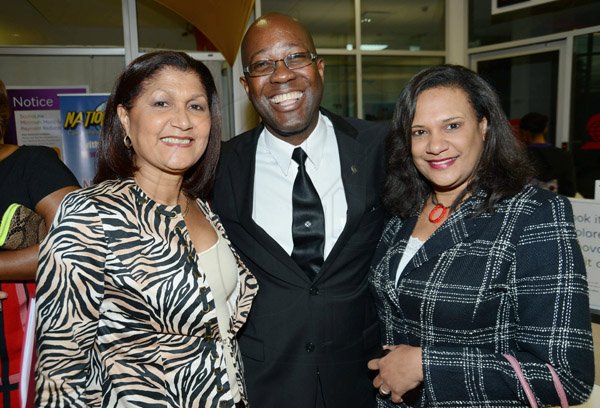Rudolph Brown/Photographer
Hugh Reid, President of Scotia Insurance pose with Lorna Gordon- Elliott, (left) and  Keisha Lazarus at the Scotia Insurance 15th Anniversary branch forum at the Constant spring branch on Thursday, June 27, 2013