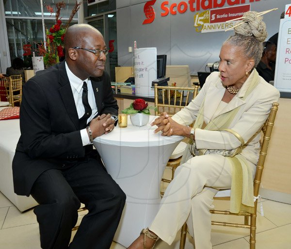 Rudolph Brown/Photographer
Hugh Reid, President of Scotia Insurance chat with Dr. Sherrill Chong at the Scotia Insurance 15th Anniversary branch forum at the Constant spring branch on Thursday, June 27, 2013