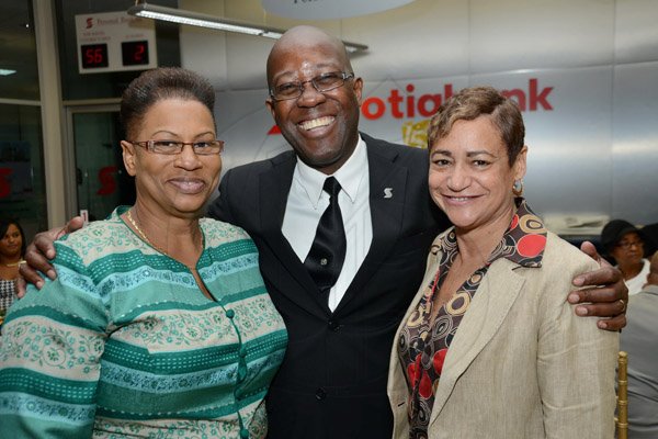Rudolph Brown/Photographer
Hugh Reid, President of Scotia Life Insurance pose with Denise Henry James. (right) Attorney at law and Estate Planning Consultant and Arlene Powell at the Scotia Insurance 15th Anniversary branch forum at the Constant spring branch on Thursday, June 27, 2013