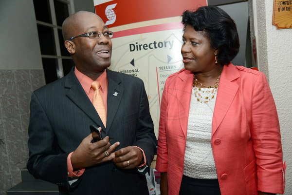 Rudolph Brown/Photographer
Hugh Reid, President of Scotia Life Insurance chat with Jennifer Llewellyn at the Ocho Rios branch Scotia Insurance 15th Anniversary cocktail forum on Tuesday, September 24, 2013