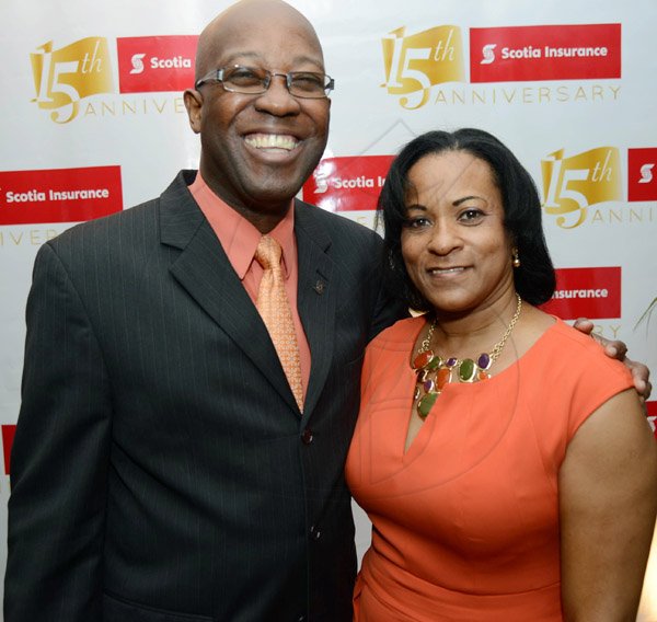 Rudolph Brown/Photographer
Hugh Reid, President of Scotia Life Insurance pose with Jasmine Davis-Turner at the Ocho Rios branch Scotia Insurance 15th Anniversary cocktail forum on Tuesday, September 24, 2013