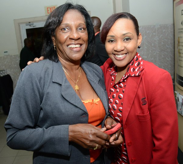 Rudolph Brown/Photographer
Melissa Green, (right) pose with Nellie Harris at the Ocho Rios branch Scotia Insurance 15th Anniversary cocktail forum on Tuesday, September 24, 2013