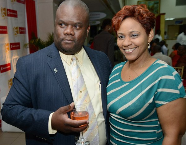 Rudolph Brown/Photographer
Fitzaudy Wright, Branch Manager pose with Colleen Hoilett at the Ocho Rios branch Scotia Insurance 15th Anniversary cocktail forum on Tuesday, September 24, 2013