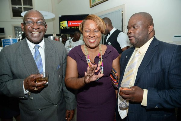 Rudolph Brown/Photographer
Fitzaudy Wright, (right) Branch Manager share a joke with Ernest Smith and Suzan Sinclair, Regional Sales Manager at the Ocho Rios branch Scotia Insurance 15th Anniversary cocktail forum on Tuesday, September 24, 2013