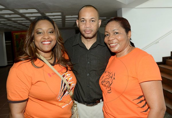 Rudolph Brown/Photographer
Andre Vassell pose with Yolande Donaldson, (left) and Grace Anderson at the Scotiabank Sales Conference 2014 awards "We Dominated We Conquered Now hear us ROAR" at the Jamaica Conference Centre on Saturday January 25,2014