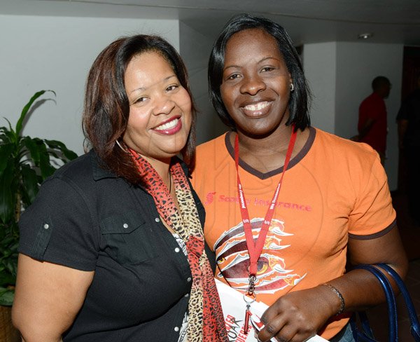 Rudolph Brown/Photographer
Jacqueline Hamilton, (left)  pose with Lean Sutherland at the Scotiabank Sales Conference 2014 awards "We Dominated We Conquered Now hear us ROAR" at the Jamaica Conference Centre on Saturday January 25,2014