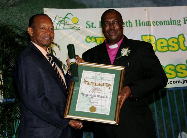 Winston Sill / Freelance Photographer
The St. Elizabeth Homecoming Foundation Limited (SEHF) 20th Annual Golden Awards Banquet, held at the Jamiaca Pegasus Hotel, New Kingston on Wednesday night November 28, 2012. Here are Kenry Jackson (left); presenting to Rev. Godfrey Watson (right), for Religion.