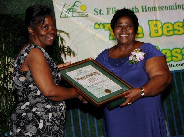 Winston Sill / Freelance Photographer
The St. Elizabeth Homecoming Foundation Limited (SEHF) 20th Annual Golden Awards Banquet, held at the Jamiaca Pegasus Hotel, New Kingston on Wednesday night November 28, 2012. Here are Ouida Nesbeth Dunn (left), presenting to Laurna Wint (right), for Community Service.