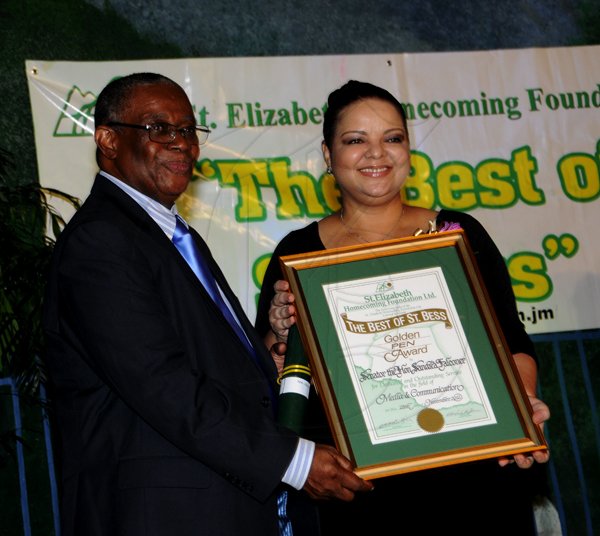 Winston Sill / Freelance Photographer
The St. Elizabeth Homecoming Foundation Limited (SEHF) 20th Annual Golden Awards Banquet, held at the Jamiaca Pegasus Hotel, New Kingston on Wednesday night November 28, 2012. Here are George Watson (left), Founder and CEO, SEHF; presentinf to  Senator Sandrea Folconer (right), for Media and Communication.